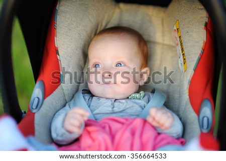 Portrait of sweet baby girl in car seat