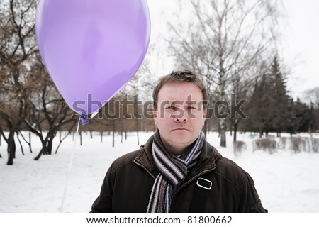 Man holding purple balloon