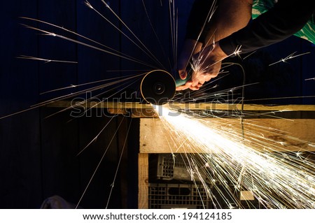 Metal grinding on steel pipe close up