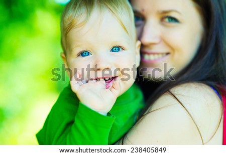 Happy mother and son laughing together outdoors