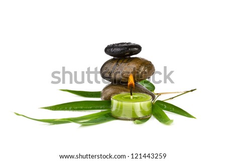 zen pebbles with bamboo leafs and candle, isolated on white background