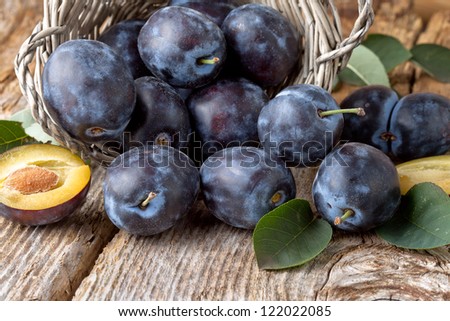 group of fresh plums on wood  background