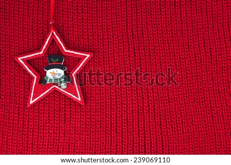 Christmas decoration over red wool fabric background