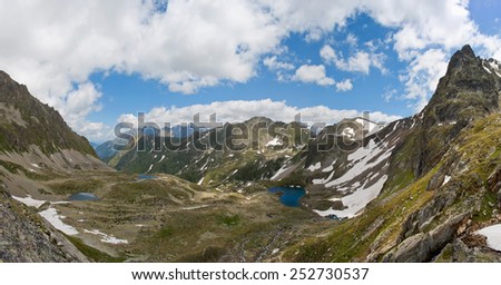 three lakes in the mountains under blue sky
