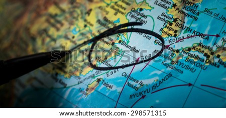 A black pen circles the highest populated city in the world, Shanghai, to highlight it as a point of interest on a three dimensional globe. A place of much of the world\'s trade and economic growth.