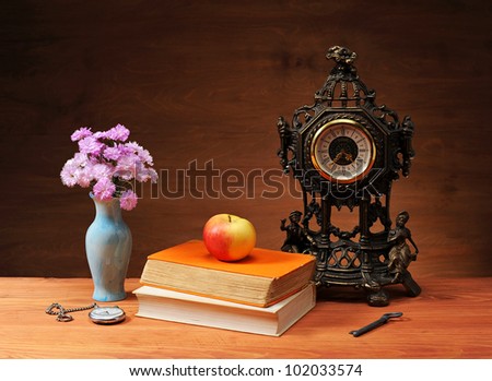 Carnation in the vase on the table and books