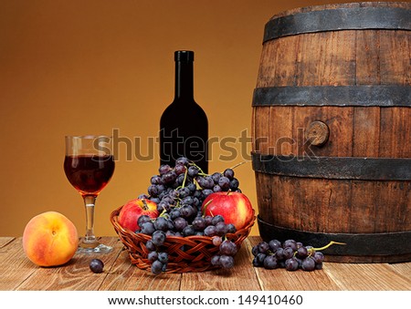 Fresh fruit, wine and barrel on the table