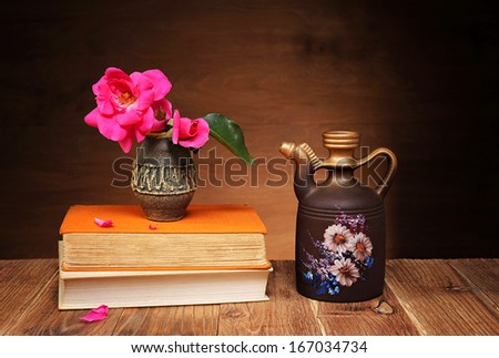 Roses in a vase on the table and books