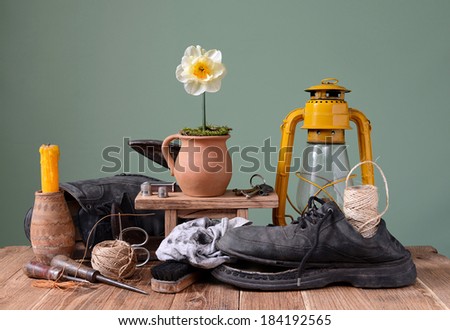 Old shoes and shoemaker tools on the table