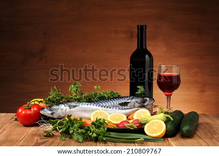 Mackerel fish, vegetables and wine on the table