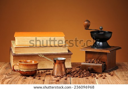 Coffee grinder, coffee pot and books on the table