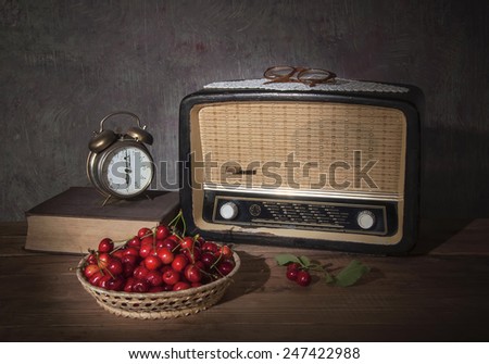 The old radio, books, clock and cherries