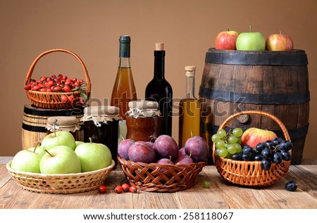 Apples, plums, grapes, rosehips and jam in jars
