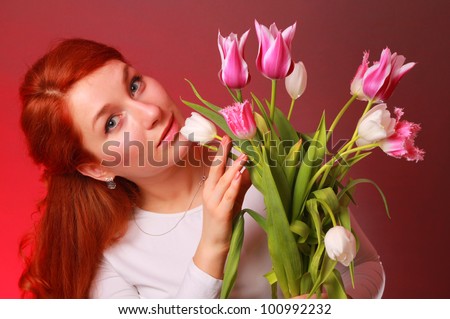 Studio shot of adorable young woman with colorful tulip bouquet/Lovely girl with tulips