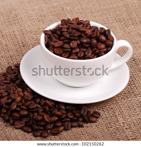Studio image of dark brown roasted over light brown canvas background on Food and Drink theme/natural coffee beans