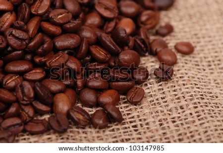 image of dark brown coffee beans on the background of tissue/tissue and coffee