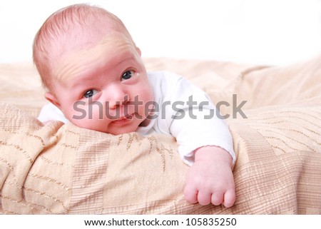 funny lovely infant baby boy over light beige textured