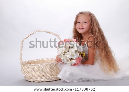 Pretty little girl with basket of flowers