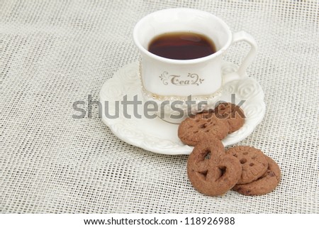 Ivory cup of tea with mint and cookies on Food and Drink theme/Image of black tea cup with yummy biscuits