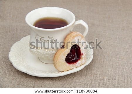 Stylish ivory tea cup with heart-shaped biscuits on Food and Drink theme/Heart shape biscuits and tea on tea time