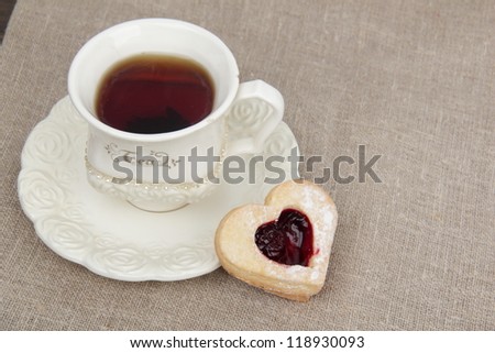 Studio image of stylish ivory tea cup with heart-shaped biscuits on Food and Drink theme/Heart shape biscuits and tea on tea time