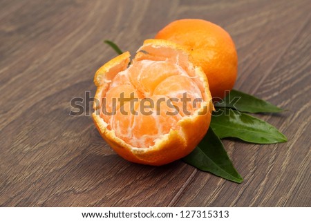 Open fresh mandarin/Organic mandarins with vitamin c and bright green leaves