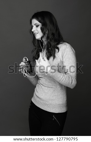 Black and White portrait of teenage girl enjoying modern music