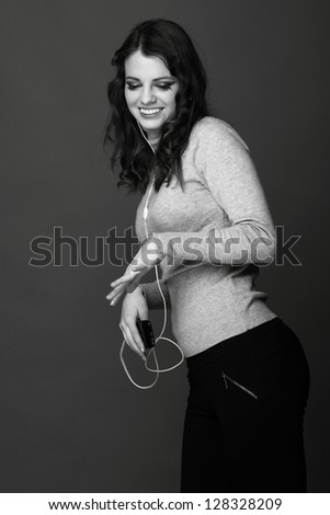 Black and White portrait of beauty woman listening music in headphone