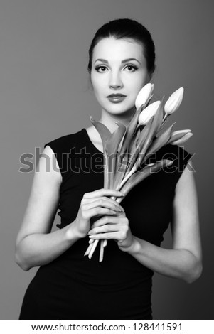 Black and White image of cute girl/Pretty woman with a bouquet of spring flowers