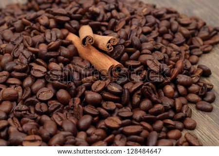 Textured background of coffee beans and cinnamon/Cinnamon and coffee beans on Food and Drink theme