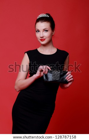 Woman with a good figure in evening dress with a handbag