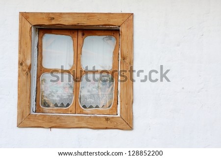 An old window in a wooden frame/Image of traditional ukrainian window