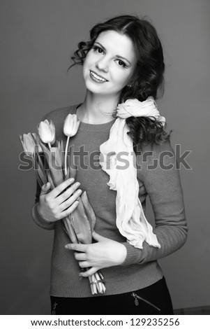 Retro photo of a cute girl with flowers/Black and White image of girl with a bouquet of spring flowers
