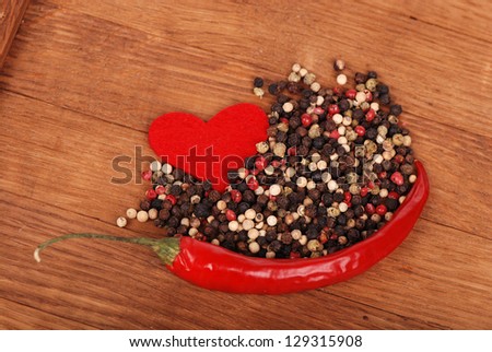 Cayenne pepper and many other spices/Red pepper and spices with a paper red heart on holiday