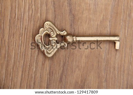 Antique metal key/Old key on wooden table