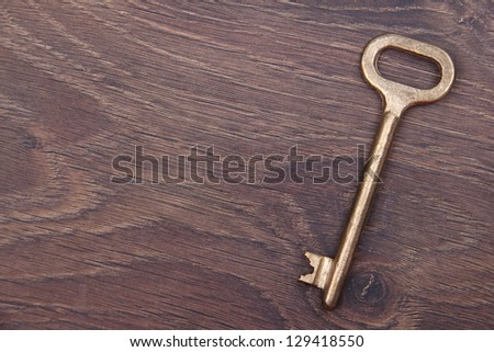 Old key/Antique metal key on dark wooden background