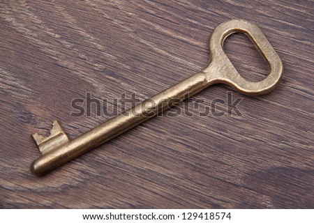 Antique key on dark wooden background