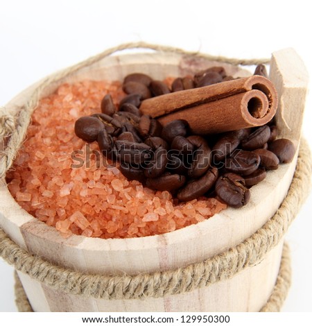 Wooden bucket with natural sea salt and cinnamon on white background/Natural products for sauna and spa
