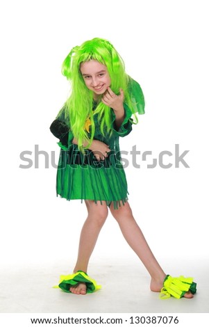 Happy girl in fancy dress is green and green hair on white background on Halloween