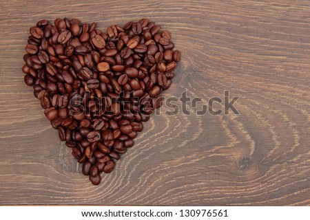 Heart laid out from natural Brazilian coffee beans and an empty space for text