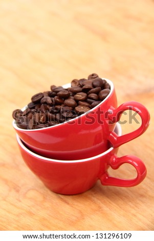 Two red coffee cups with coffee beans on Food and Drink