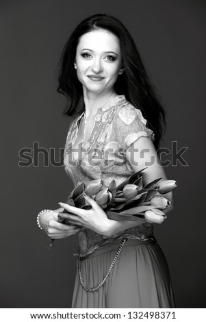 Black and white portrait of a full-length sexy woman with long dark hair