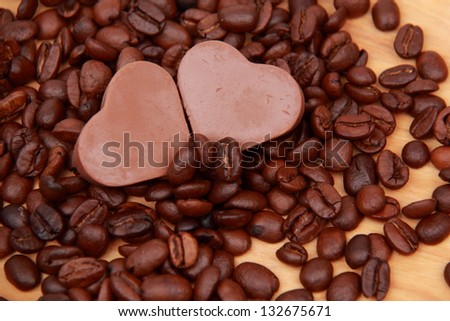 Chocolate cake and candy coffee beans on a light wooden background/Lots of coffee sweets in the form of heart