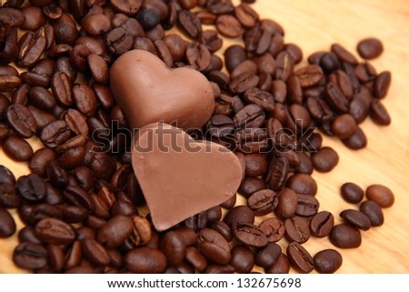 Lots of coffee sweets in shape of heart and coffee beans spilling on Holiday