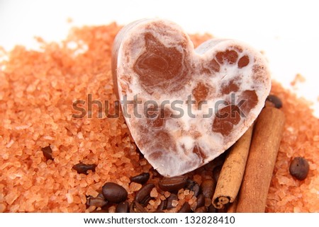 Spilled sea salt and a wooden bowl on white background