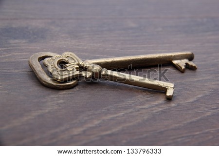Antique metal keys on dark wooden background/Vintage keys