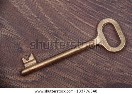 Large antique key on a dark wooden background