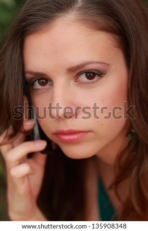 outdoor portrait of cute young woman calling over sunset/beautiful model with mobil phone