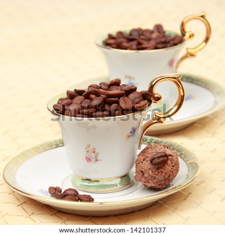 Classic coffee cup chocolate candy on the beige tablecloth on Food and Drink