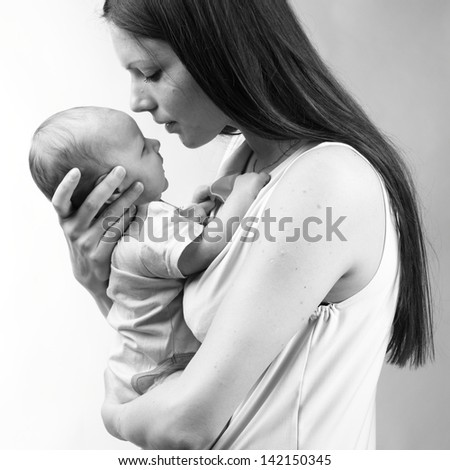 Black And White Art Photo Of Beautiful Mother Holding Baby Boy